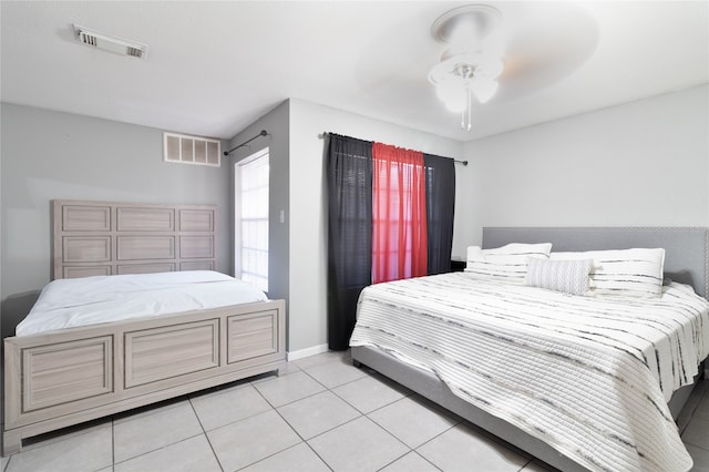 tiled bedroom featuring ceiling fan