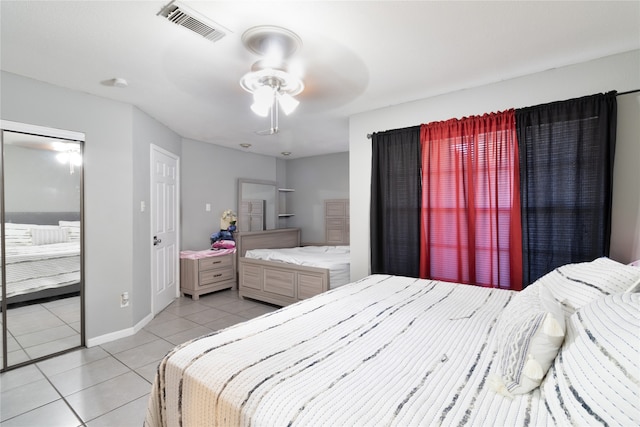 tiled bedroom featuring ceiling fan