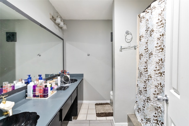 bathroom featuring walk in shower, tile patterned flooring, vanity, and toilet