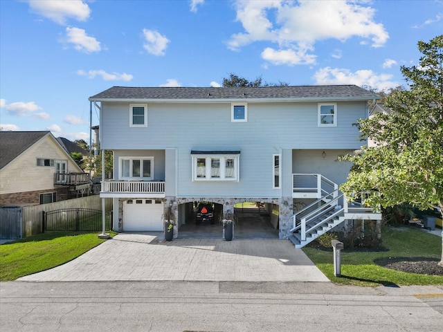 view of front of property with a front yard, a garage, and a carport