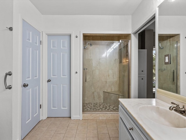 bathroom featuring tile patterned flooring, vanity, and a shower with shower door