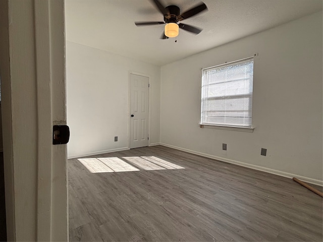 empty room with ceiling fan and hardwood / wood-style flooring