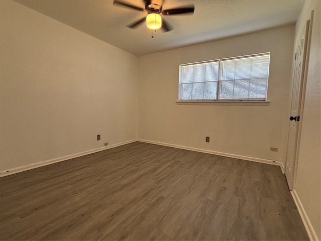 spare room featuring dark hardwood / wood-style flooring and ceiling fan