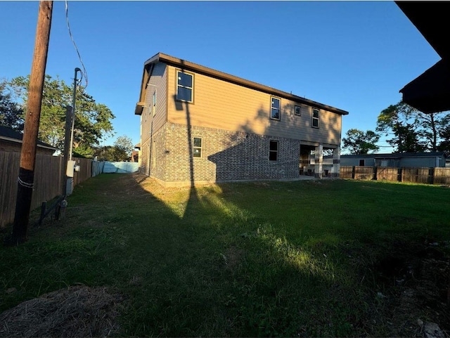 rear view of property with a yard