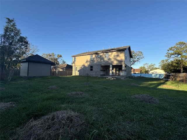 back of property featuring a lawn