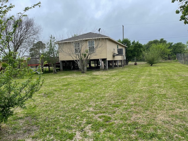 315 20th St, San Leon, TX 77539 - rear view of house with a lawn and a wooden deck