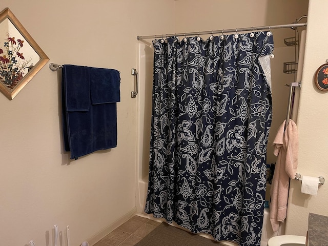 315 20th St, San Leon, TX 77539 - full bathroom featuring shower / bathtub combination with curtain, tile patterned flooring, and toilet