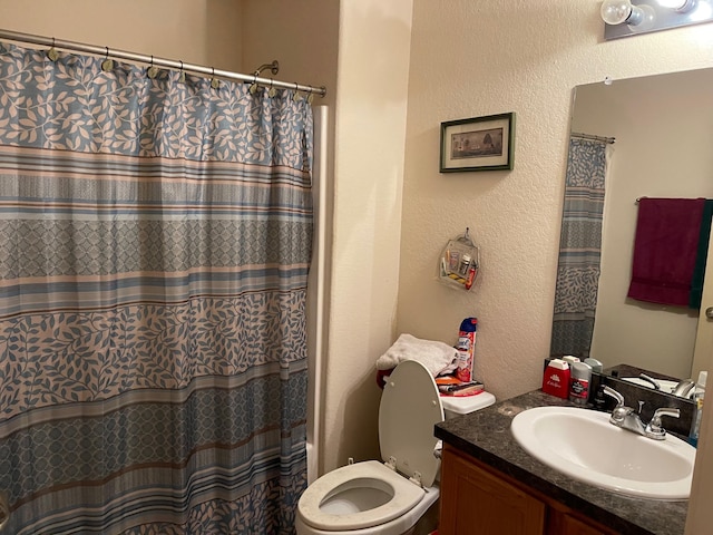 315 20th St, San Leon, TX 77539 - bathroom featuring a textured wall, vanity, toilet, and a shower with curtain