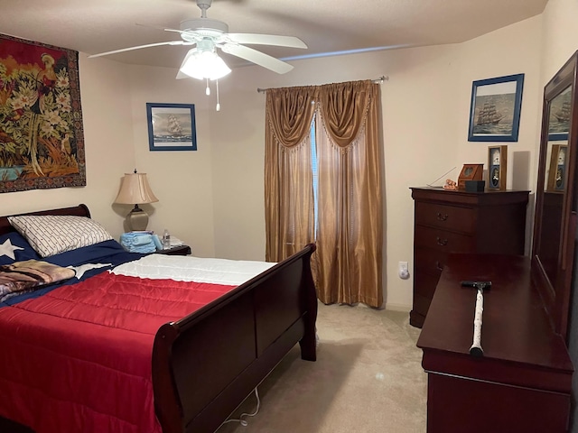 315 20th St, San Leon, TX 77539 - bedroom with light colored carpet and a ceiling fan
