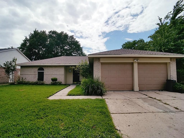 ranch-style house with a front yard and a garage