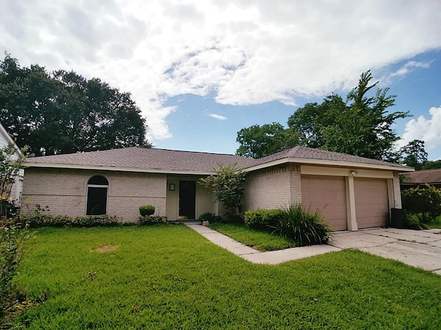 ranch-style home with a front lawn and a garage