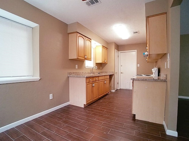 kitchen featuring light brown cabinets, white range, dark hardwood / wood-style floors, and sink