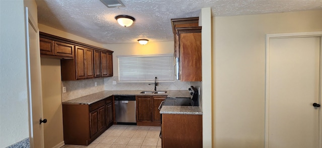 kitchen with light stone counters, stainless steel appliances, light tile patterned floors, backsplash, and sink