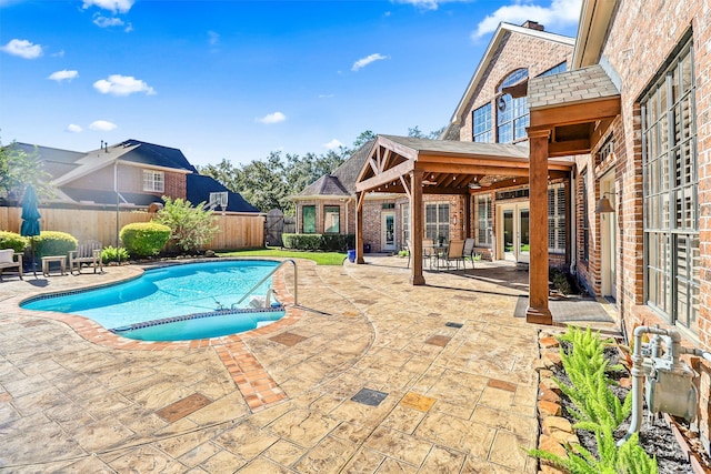 view of pool with french doors and a patio area