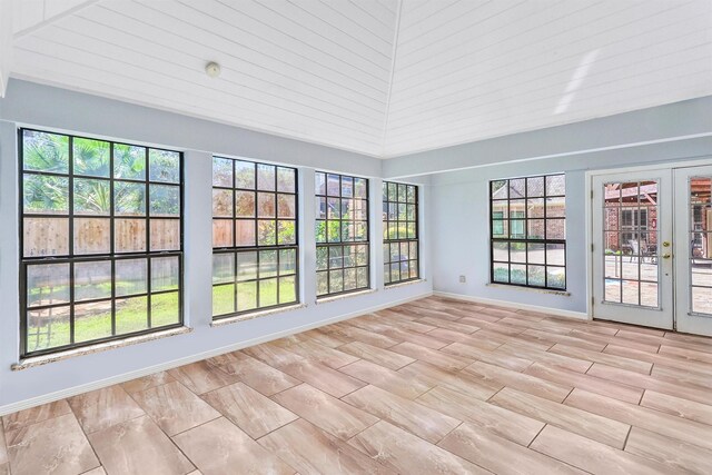 unfurnished sunroom featuring french doors and lofted ceiling