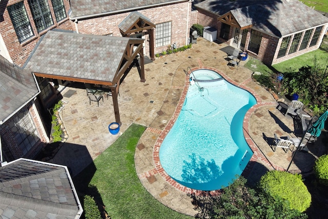 view of swimming pool featuring a patio area