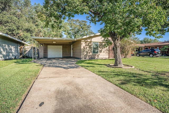 ranch-style home with a garage, a front yard, and a carport