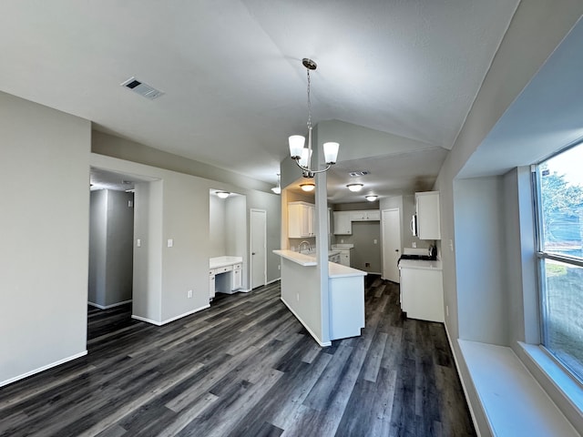 kitchen featuring a chandelier, white cabinets, dark hardwood / wood-style floors, hanging light fixtures, and lofted ceiling