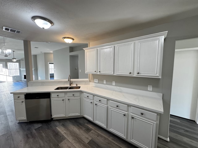 kitchen featuring dishwasher, a textured ceiling, white cabinetry, and sink