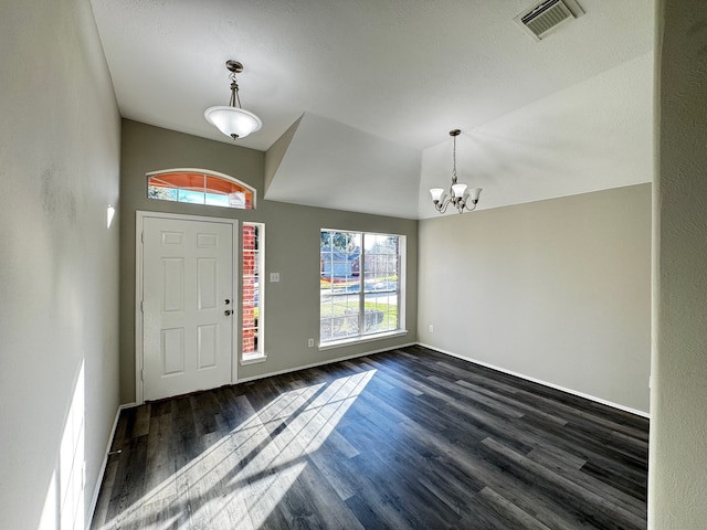 entryway with dark hardwood / wood-style flooring and an inviting chandelier