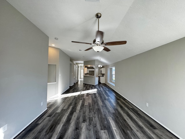 unfurnished living room with dark hardwood / wood-style floors, ceiling fan, a textured ceiling, and vaulted ceiling