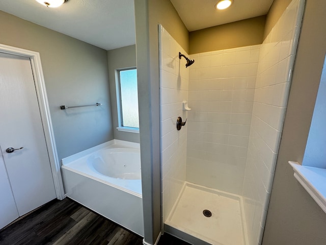 bathroom with separate shower and tub and hardwood / wood-style floors