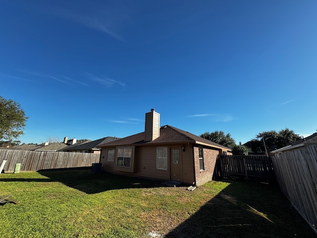 rear view of house with a lawn