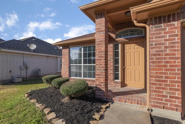 doorway to property featuring a lawn