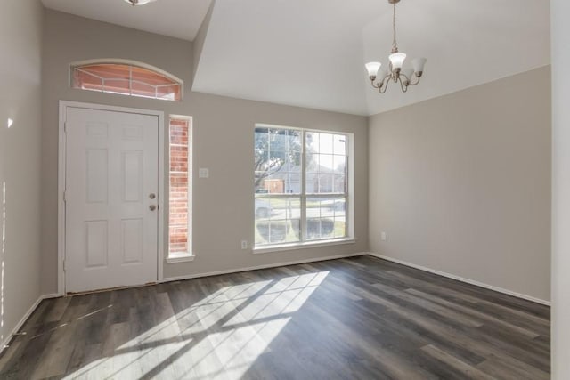 foyer with dark hardwood / wood-style flooring, a chandelier, and a healthy amount of sunlight