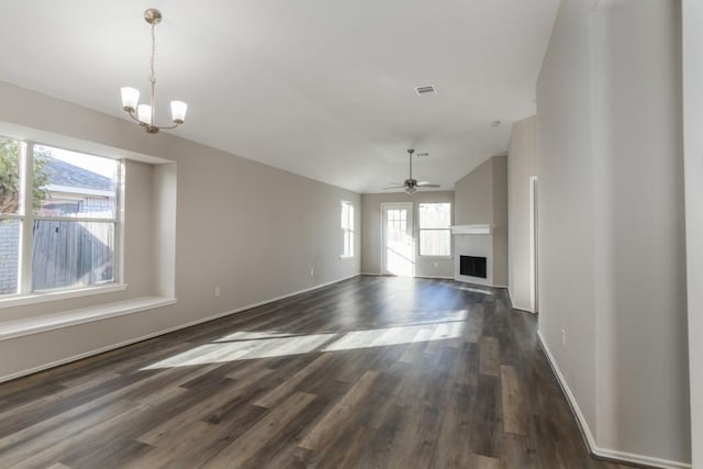 unfurnished living room featuring dark hardwood / wood-style flooring and ceiling fan with notable chandelier