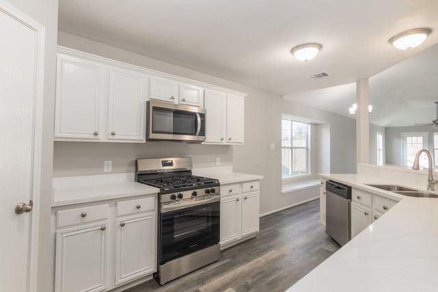 kitchen featuring ceiling fan, sink, white cabinets, and appliances with stainless steel finishes