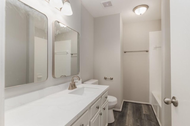 bathroom with toilet, wood-type flooring, and vanity