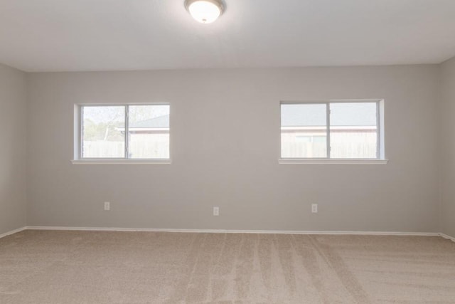 carpeted spare room with plenty of natural light