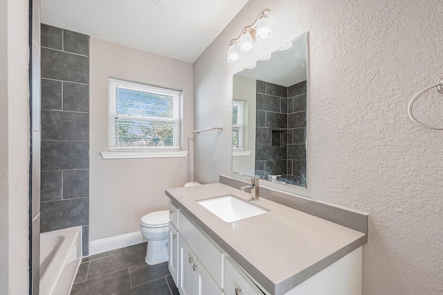 full bathroom featuring tile patterned floors, tiled shower / bath, vanity, and toilet