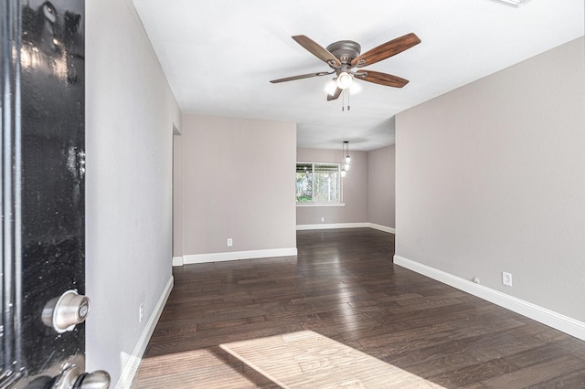 unfurnished room with ceiling fan and dark hardwood / wood-style flooring