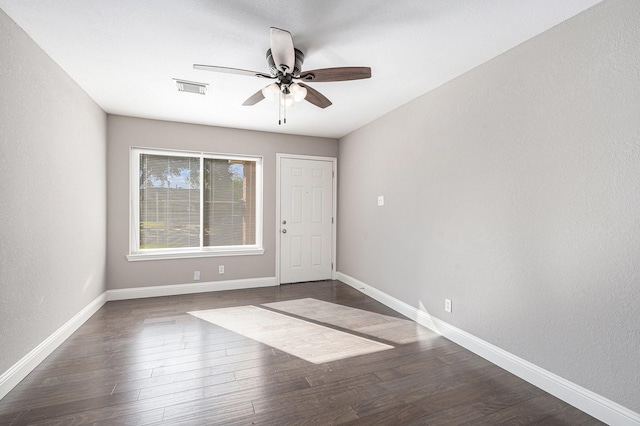 unfurnished room with ceiling fan and dark hardwood / wood-style flooring