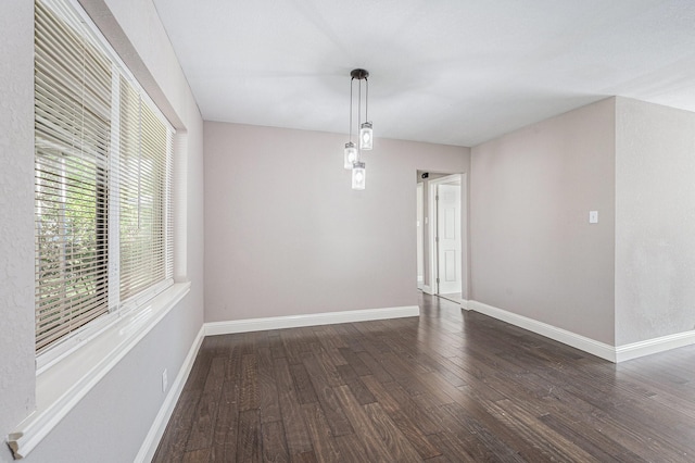 empty room featuring dark wood-type flooring