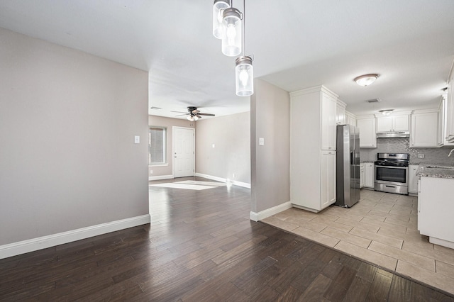 kitchen with decorative backsplash, stainless steel appliances, ceiling fan, light hardwood / wood-style flooring, and white cabinetry