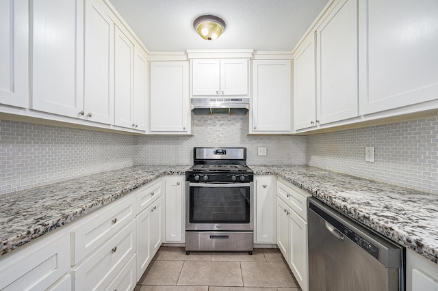 kitchen with white cabinets, appliances with stainless steel finishes, and tasteful backsplash