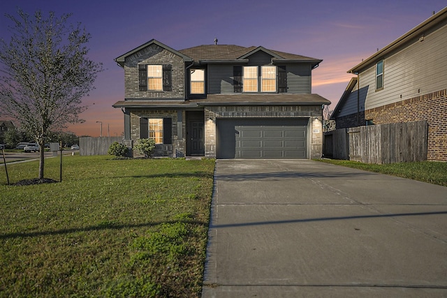 view of front property featuring a lawn and a garage