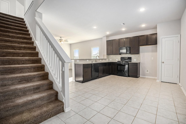 kitchen featuring decorative backsplash, light tile patterned floors, ceiling fan, and black appliances