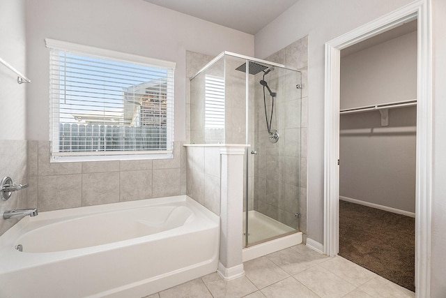 bathroom featuring tile patterned floors and independent shower and bath