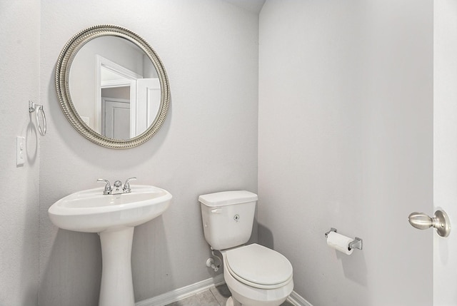 bathroom featuring tile patterned flooring and toilet