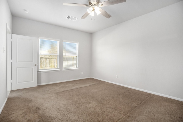 spare room featuring carpet and ceiling fan