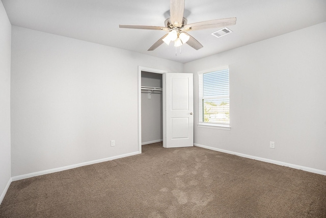 unfurnished bedroom featuring ceiling fan, a closet, and carpet