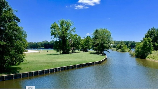 exterior space with a water view and a lawn