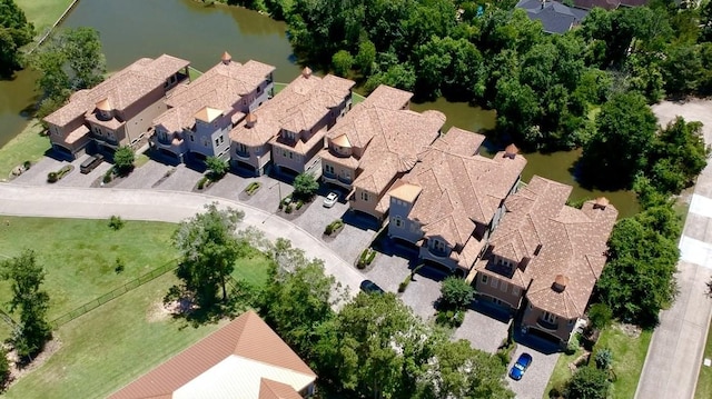 birds eye view of property with a water view and a residential view