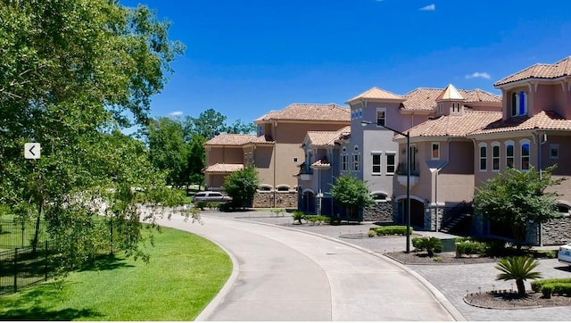 view of road with a residential view and curbs