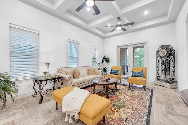 living room featuring ceiling fan, french doors, coffered ceiling, beamed ceiling, and a towering ceiling