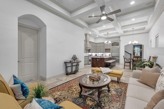 living room with beamed ceiling, ceiling fan with notable chandelier, coffered ceiling, and sink